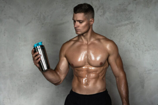 muscular man drinking whey protein other sport supplement from metal shaker 1