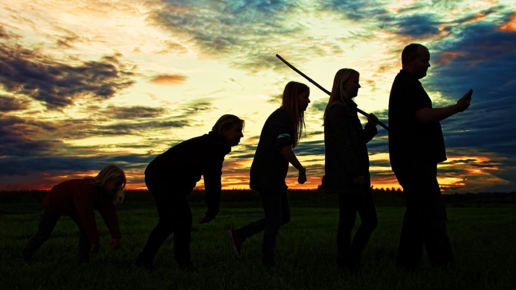 Human Behavior silhouette photo of group people standing on grass