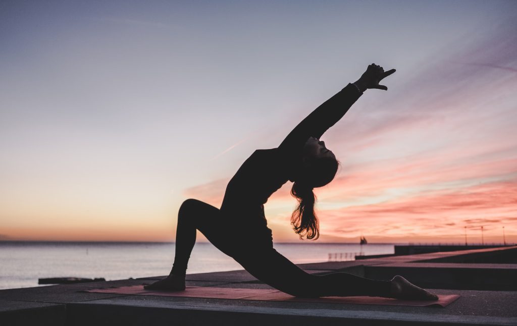 work out silhouette photography of woman doing yoga