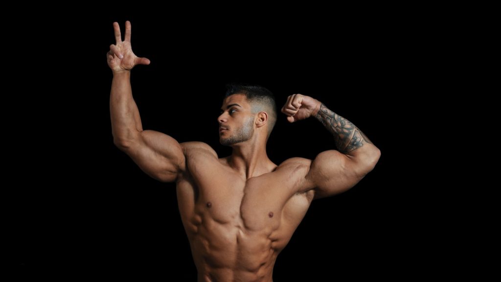 Reasons You May Be Gaining Weight topless man with hands up