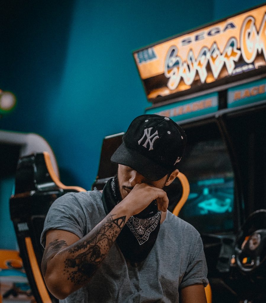 Emotional Reactions man sits near racing arcade machine