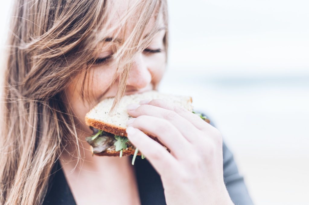 Clean Eating woman eating sandwich