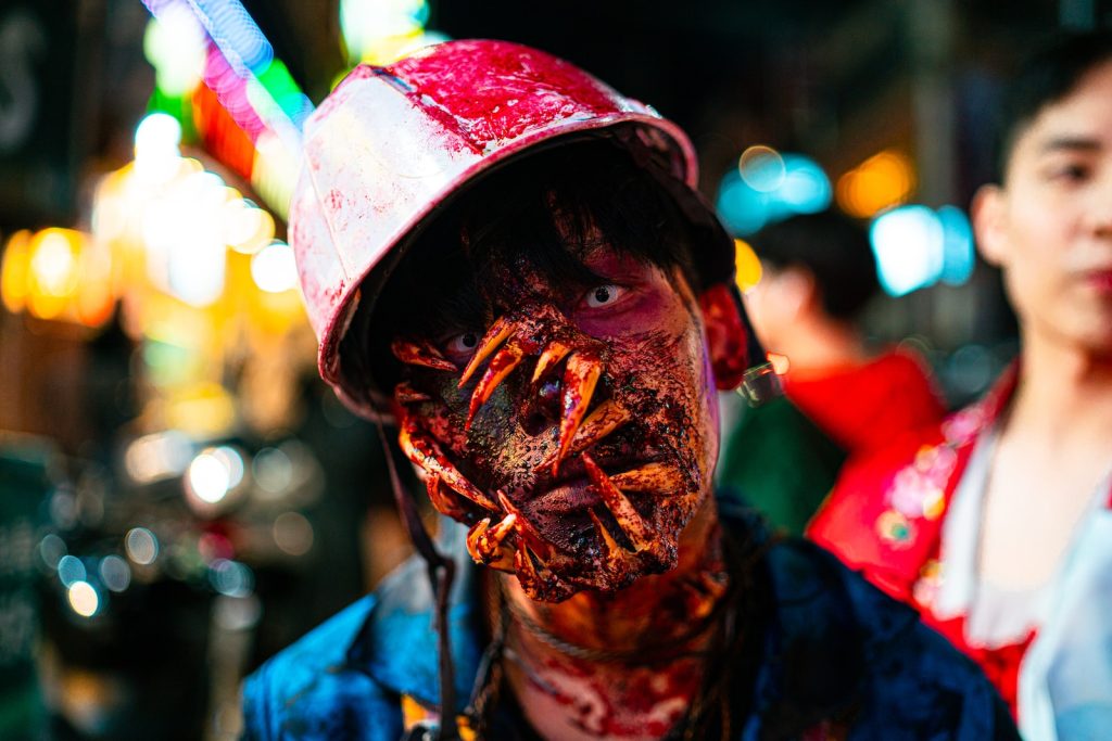 Zombie Apocalypse a man with a bloody face and a hat on
