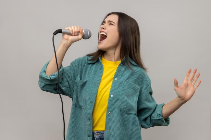 Premium Photo Photo woman singing songs in microphone singer making performance keeps eyes closed